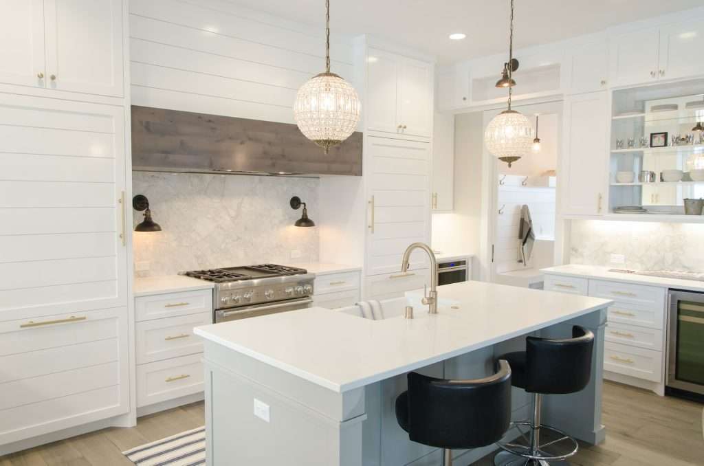 a white kitchen interior with hanging lights