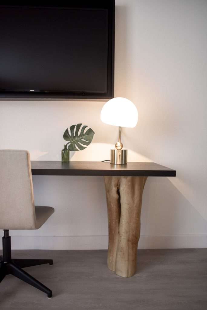Stainless Steel Base White Shade Table Lamp on Brown Wooden Desk